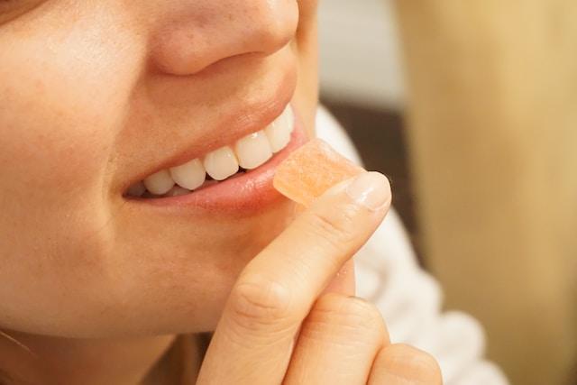 Woman eating a CBD gummy