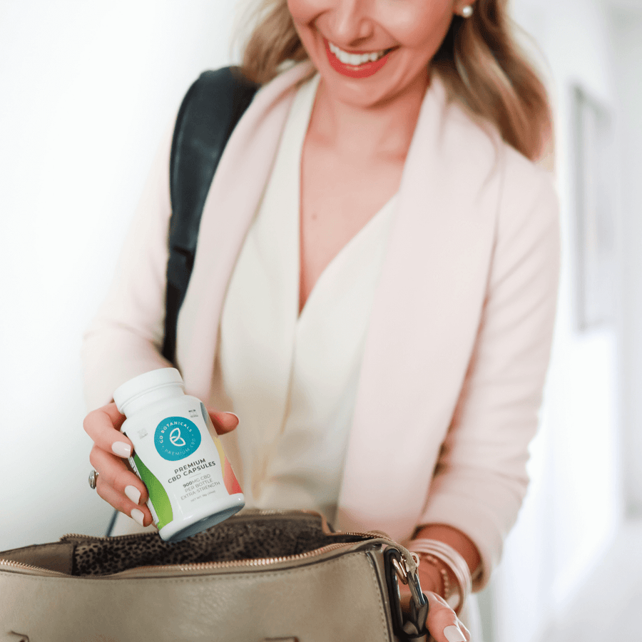 Woman Packing Go Botanicals CBD Capsules with Magnesium in her mom bag