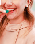 Woman Eating Go Botanicals Extra Strength Gummy